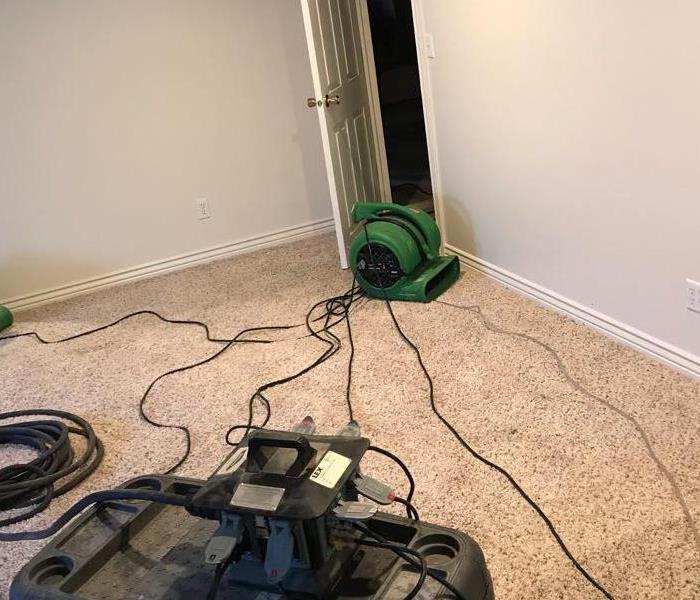 green equipment on grey carpet in a living room