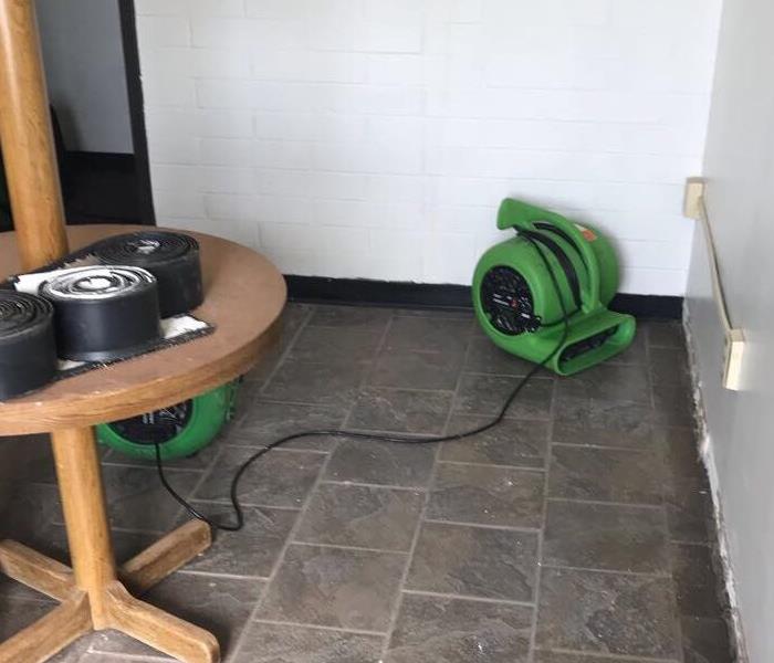 a room with green drying equipment in it