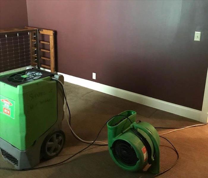 Dehumidifier and air mover in room.