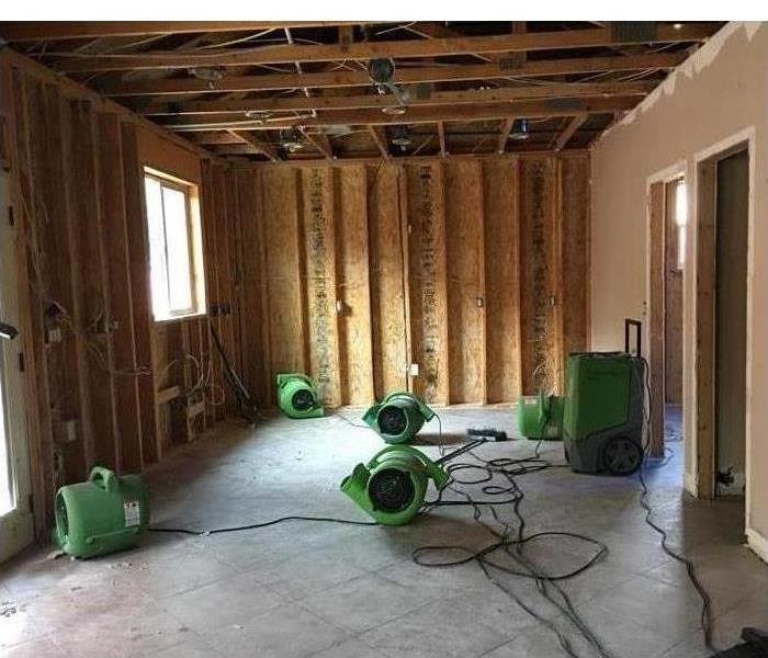 Drywalls from a room have been removed and also the ceiling, there are eight air scrubbers placed in different places