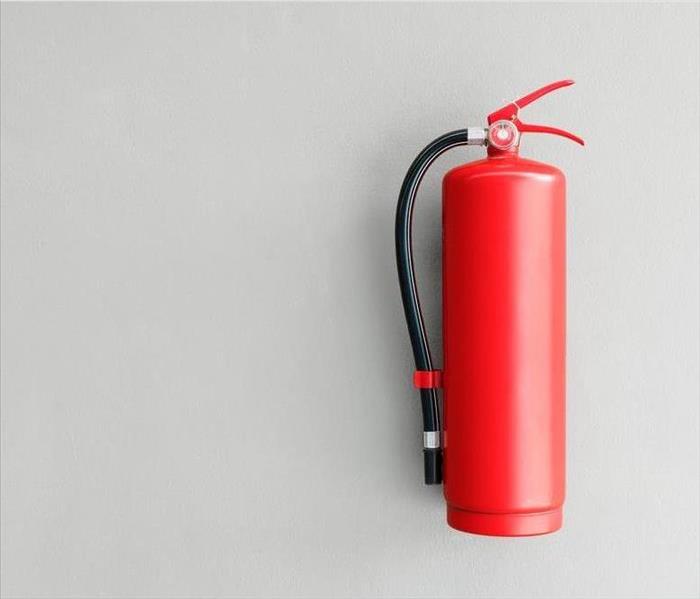 Fire extinguisher on gray wall